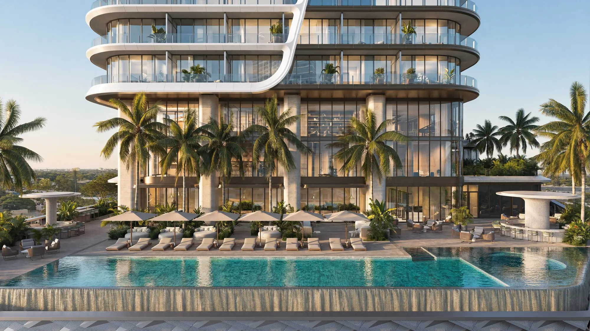 The resort pool deck beneath the tower’s curved balconies