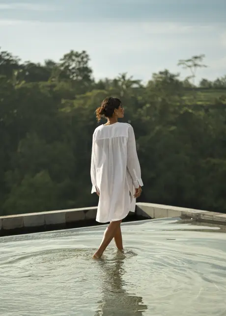 Resident walking through a reflecting pool